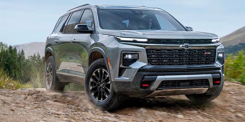 A large gray Chevrolet Traverse parked outdoors on a paved surface