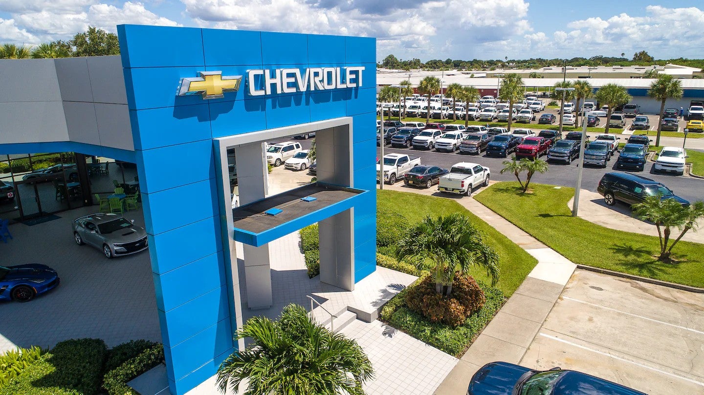 Aerial view of a Chevrolet dealership showing a large blue entrance structure
