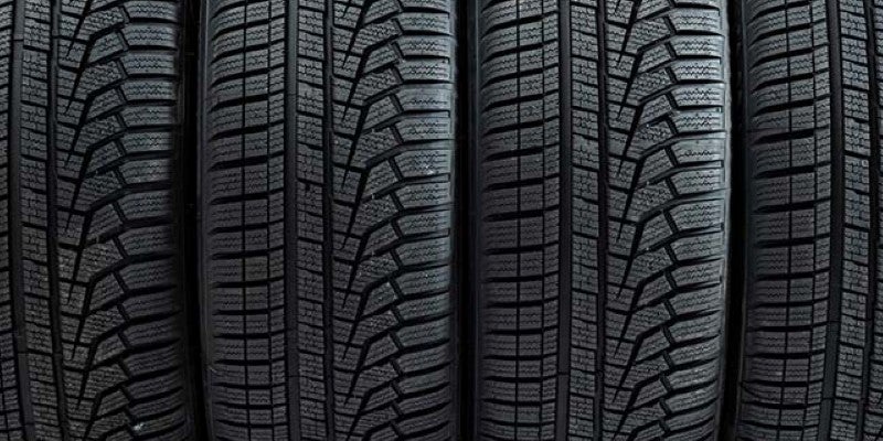 A close-up row of vehicle tires lined up side by side